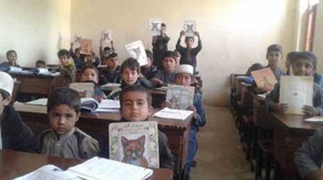 Afghan kids in a classroom with Hoopoe books