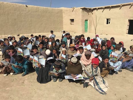 Kids in Afghanistan with copies of The Magic Horse