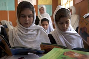 Afghan girls reading Hoopoe Books in class