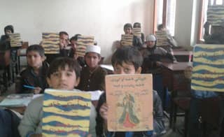 Afghan kids in a classrooom with Hoopoe books from Moska Mobile Library