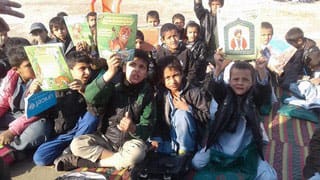 Young Afghan boys with Hoopoe Books