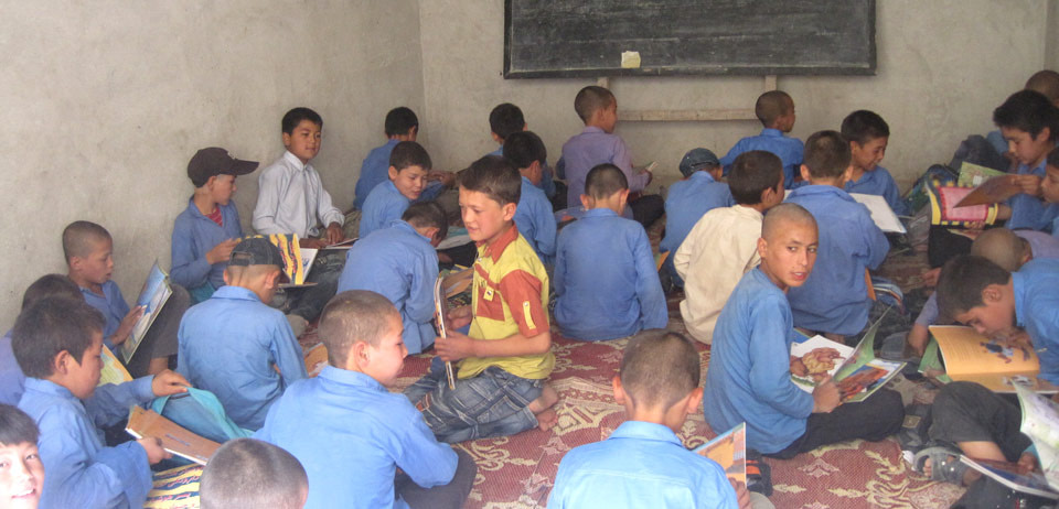 Students seated on the floor of an Afghan classroom