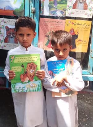 Afghanistan children holding books- distributed by The Hadia Foundation