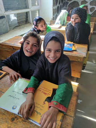 2 happy Afghan girls with Hoopoe books
