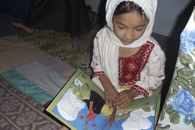 Afghan girl reading The Farmer's Wife