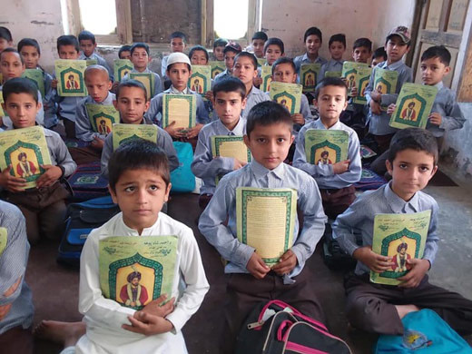 Classroom of Afghan boys with copies of The Wisdom of Ahmad Shah