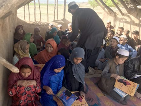 Distributing Hoopoe books in Baharak District Afghanistan