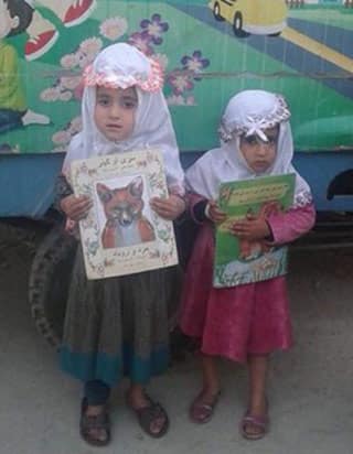 Afghan kids with Hoopoe books from Moska Mobile Library