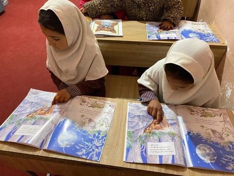 2 Afghan girls reading The Man and the Fox