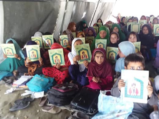 Classroom of Afghan girls with copies of The Wisdom of Ahmad Shah