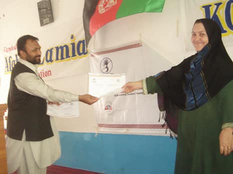 Teacher receiving training certificate of completions 