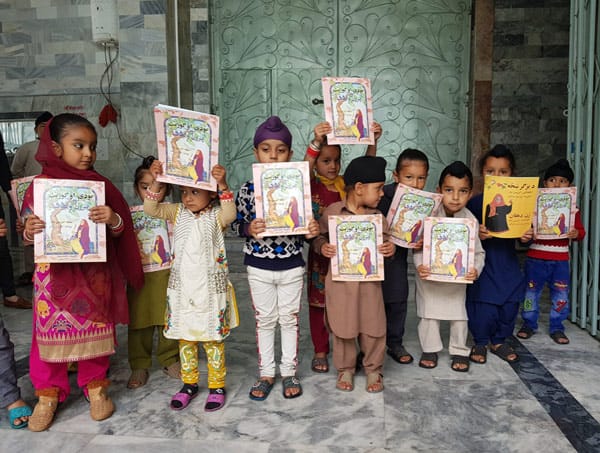 Children in Kabul, Afghanistan holding books- distributed by Hoopoe Books