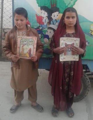 Afghan kids with Hoopoe books from Moska Mobile Library
