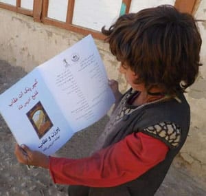 Afghanistan child reading book - Shugni Project