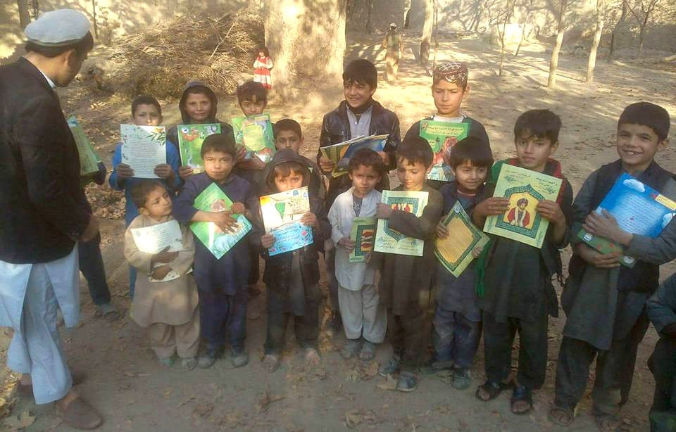Kids holding Hoopoe Books from Kapisa Province Afghanistan