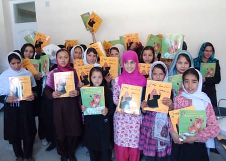 Girls in Afghanistan holding Hoopoe Books