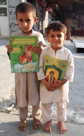 2 Afghan children with Hoopoe books