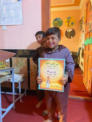 Boy smiling with the book Boy Without A Name