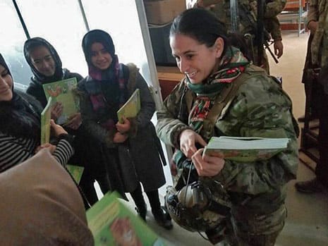 Army officer handing out Hoopoe books in Afghanistan