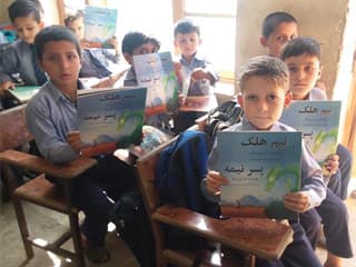 Afghan boys in a classroom with Neem the Half-Boy