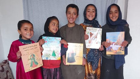A boy and his 4 sisters with Hoopoe books in Afghanistan