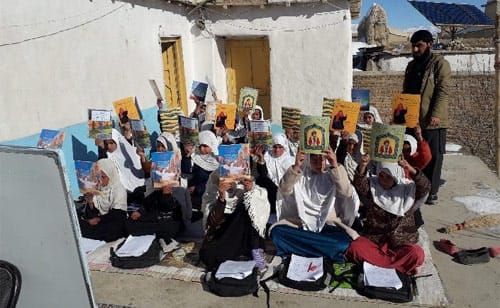 Outdoor classroom of kids with Hoopoe books in Paktia